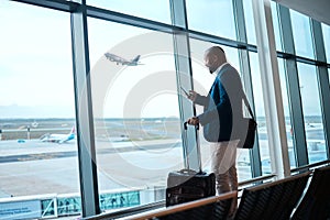 Black man with phone, airport window and plane taking off, checking flight schedule terminal for business trip