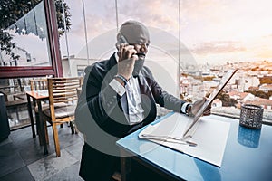 Black man on the phone in a bar