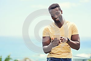 Black man, phone and typing on social media, app or text and message, communication and mockup blue sky background