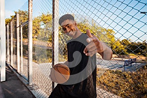 Black man playing basketball, street ball, man playing, sport competitions, afro, outdoor portrait