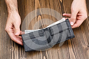 Black man's wallet in man hands