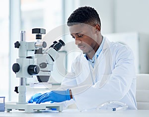 Black man, scientist and microscope for analysis, testing and study vaccine results or solution. Lens, doctor and male