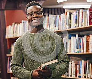 Black man, student and portrait in library for book, research and education at college with smile. African gen z learner