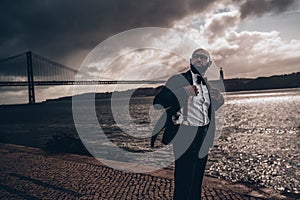 Black man in suit waiting for storm