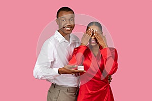 Black man surprises woman with ring, woman overjoyed closing eyes