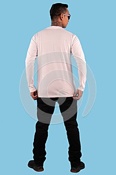 Black man tattooed wearing white long sleeve t-shirt in back view isolated on plain background