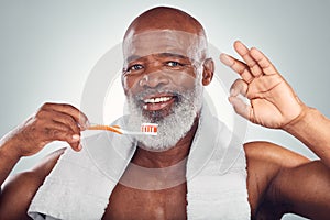 Black man, toothbrush and yes hand sign, dental and brushing teeth with hygiene isolated on studio background. Mouth