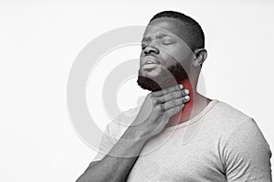 Black man touching his throat, having pain