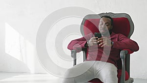 Black man uses a smartphone to communicate on the Internet.