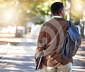 Black man, walking or backpack on campus, park nature or garden for college, university or school studying development