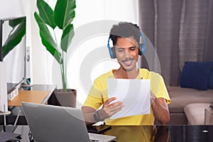Black Man Wearing Yellow T-shirt at Remote Job in His House
