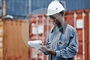 Black man working at shipping dock