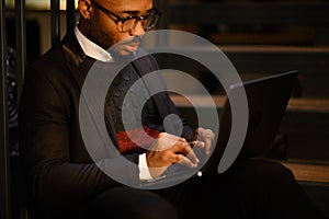 a black man works at a laptop close-up of his face. video conferences