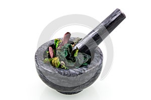 Black marble mortar with herbs