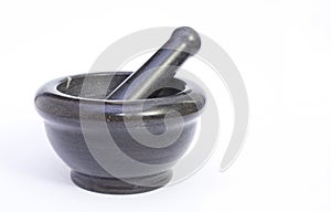 Black marble pestle and mortar on white background on left