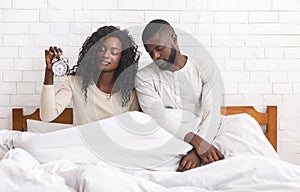 Black married couple having problems with waking up in the morning