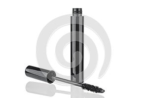 Black mascara bottle and brush close up  on white background