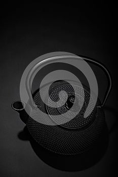 Black matal teapon on black background