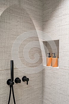Black matte shower system with sprinkler on wall in modern bathroom