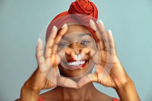 Black mature woman making heart shape and smile