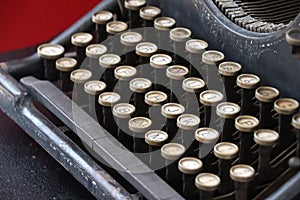 Black mechanical typewriter with white keys, horizontal