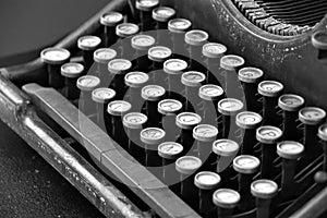 Black mechanical typewriter with white keys, horizontal. black and white