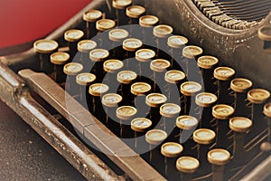 Black mechanical typewriter with white keys, horizontal, sepia and red