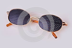 Black medical glasses with holes isolated on white background.