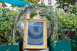 Black menu board in a frame with word Aujourd'hui (today)