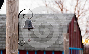 Black metal bell on a post