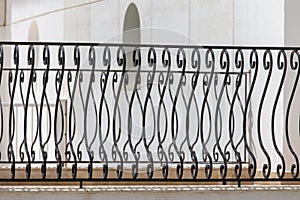 Black metal fence, close up. Beautiful decorative cast iron wrought fence with artistic forging