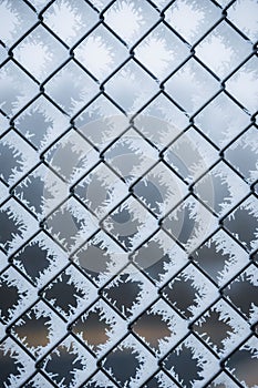 Black metal fence covered by snow