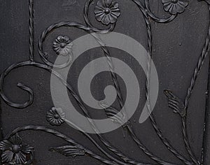 Black metal gate panel with flower design background texture