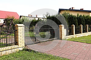 Black metal gates near private houses on street