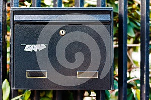 Black metal letterbox.