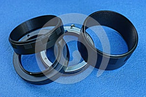 black metal macro rings lie on a blue table