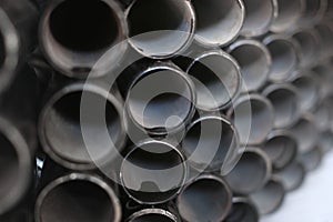 Black metal pipes for gasification or water supply. Industrial background close up