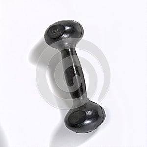 Black metal rubberized dumbbell isolate on a white background