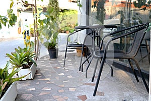 Black metal table and chairs set outside shop.