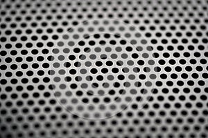 Black metal texture with round holes. Industrial background