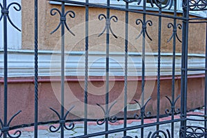 Black metal texture of steel rods in a wrought pattern on the fence