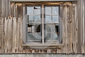 black metal window frame with weathered wood siding