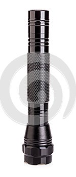 Black metallic flashlight close-up isolated on a white background photo