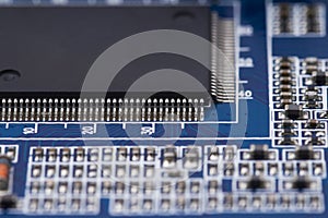 Black microchip on  on blue printed circuit board. Abstract technology black background