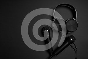 black microphone and headphones on a black background