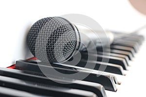 Black microphone on piano keyboard