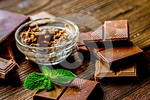 chocolate pieces with mint on wooden table background