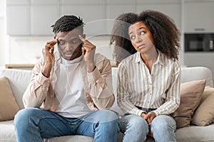 Black Millennial Couple Having Problem Sitting In Living Room Indoors