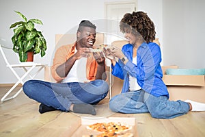 Black Millennial Couple With Pizza Celebrating Moving To New Home