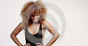 Black mixed race woman with perfect smile and big afro hair dancing